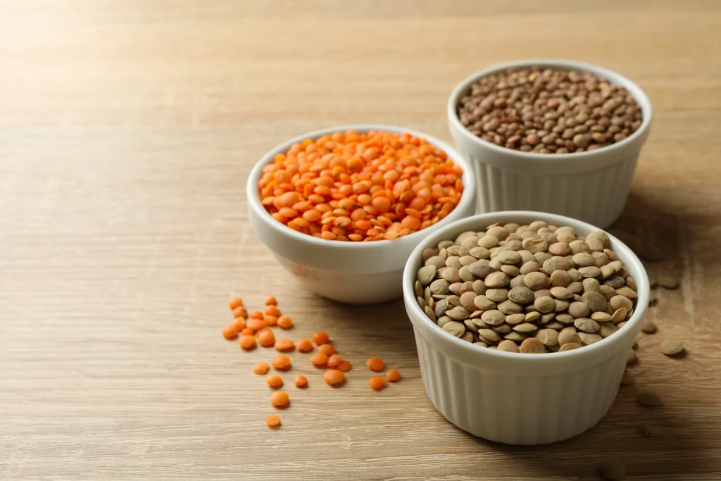 bowls with different legumes on wooden background 2026 03 25 00 28 15 utc