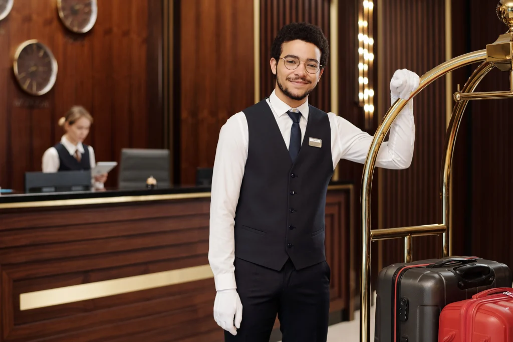 young successful bellboy in elegant uniform and wh 2026 03 25 04 47 12 utc